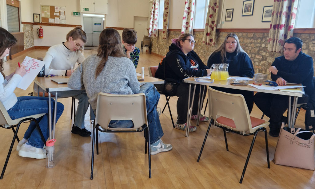 Teenagers working around 2 tables