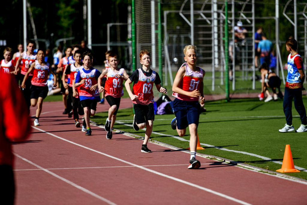 Young people running in a race at school sports day.