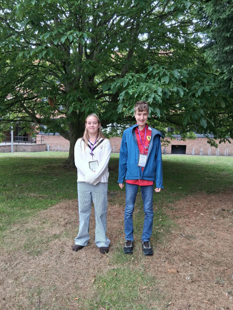 Somerset Members of Youth Parliament Eva and Luca standing in front of a tree at the UK Youth Parliament Annual Conference.