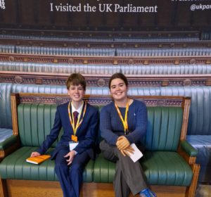James and Emma sat on one of the iconic benches at the House of Commons